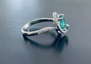 Women’s oval cut emerald and diamond ring
